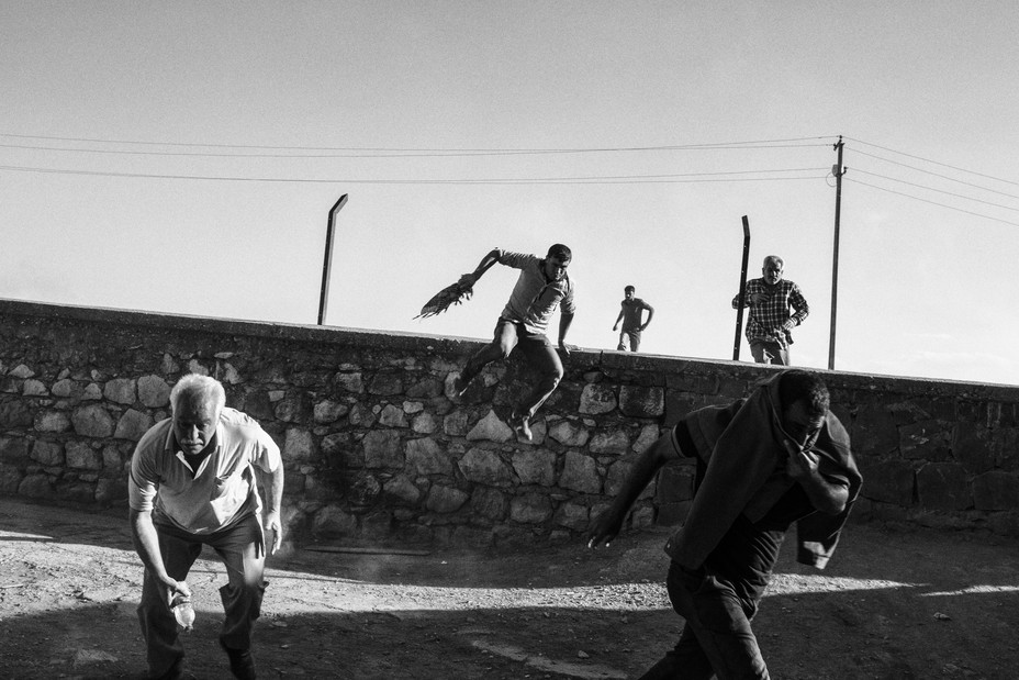 Picture of Turkish riot police using tear gas while Syrian Kurds cross the Turkish -  Syrian border.