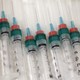 A line of syringes sits in a row