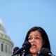 Rep. Pramila Jayapal speaking into microphones