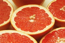 An array of pink grapefruit cut in half