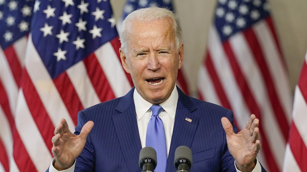 Joe Biden speaking at a microphone