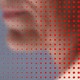 A blurred face with a matrix of red dots across it