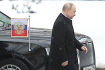 Russian President Vladimir Putin walks past his limousine