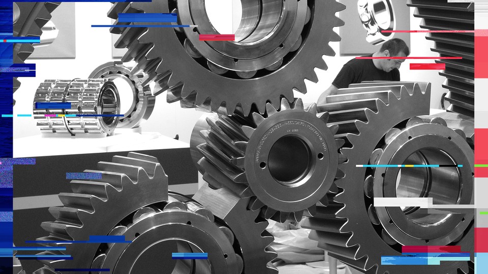 A worker is pictured behind a cog wheel during preparations at the Hanover industrial fair in 2013. 