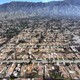 An aerial view of empty lots in a residential neighborhood, after being cleared of wildfire debris