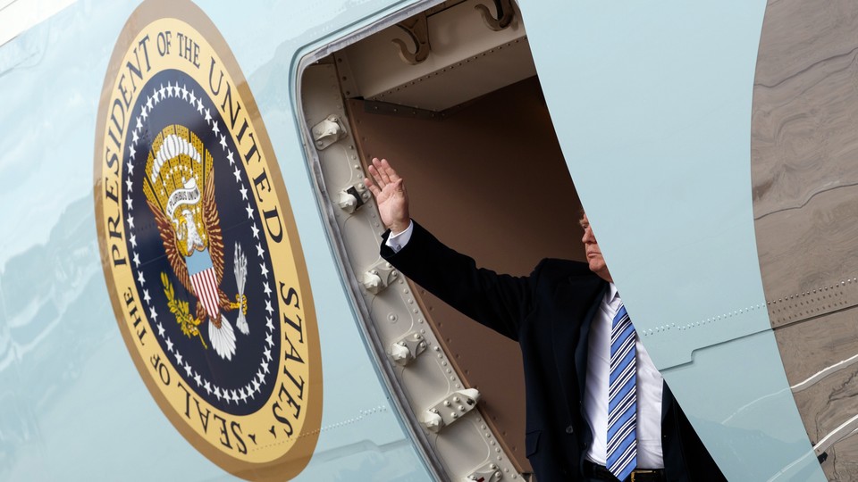 Trump waves as he boards Air Force One in March.