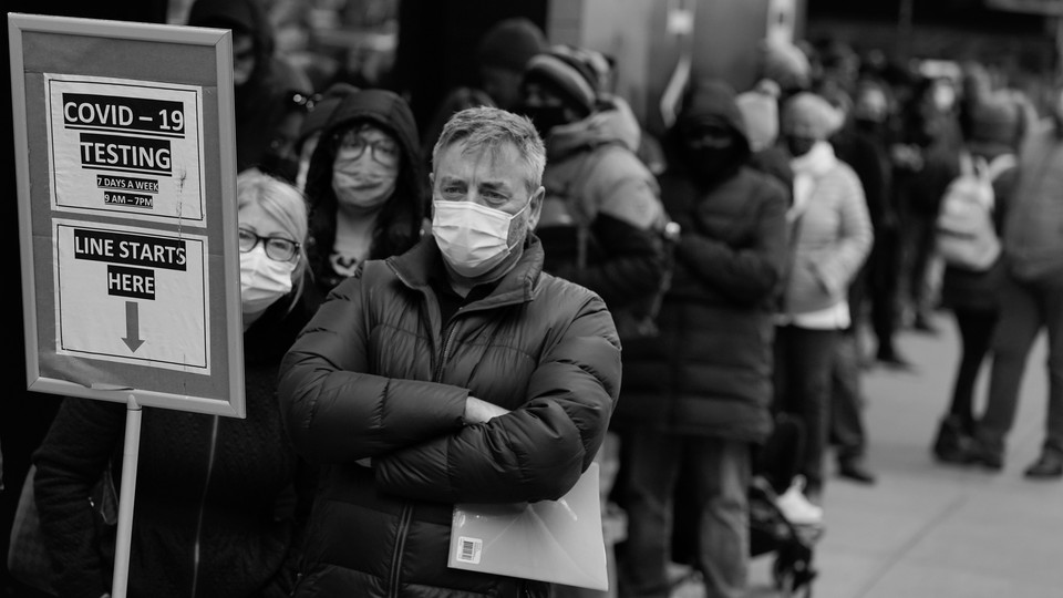 Photo of people waiting in line at a COVID-19 testing site in Times Square, New York