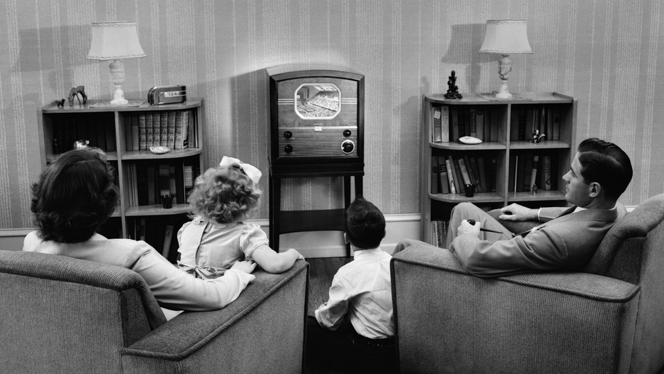 Family in front of a TV