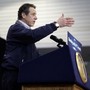 New York Governor Andrew Cuomo giving a speech at a lectern