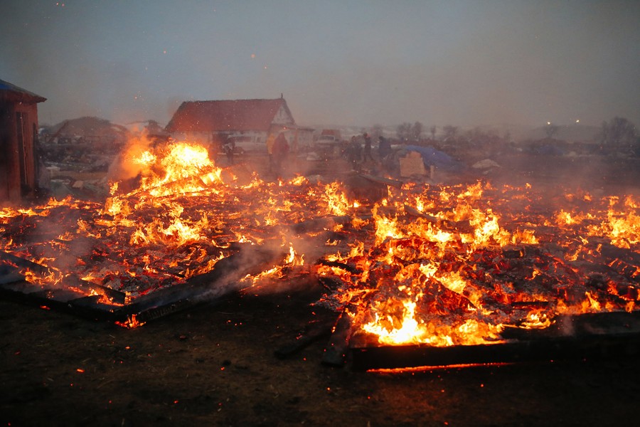 Camp structures burn ahead of the Army Corp's 2 p.m. deadline on February 22, 2017.
