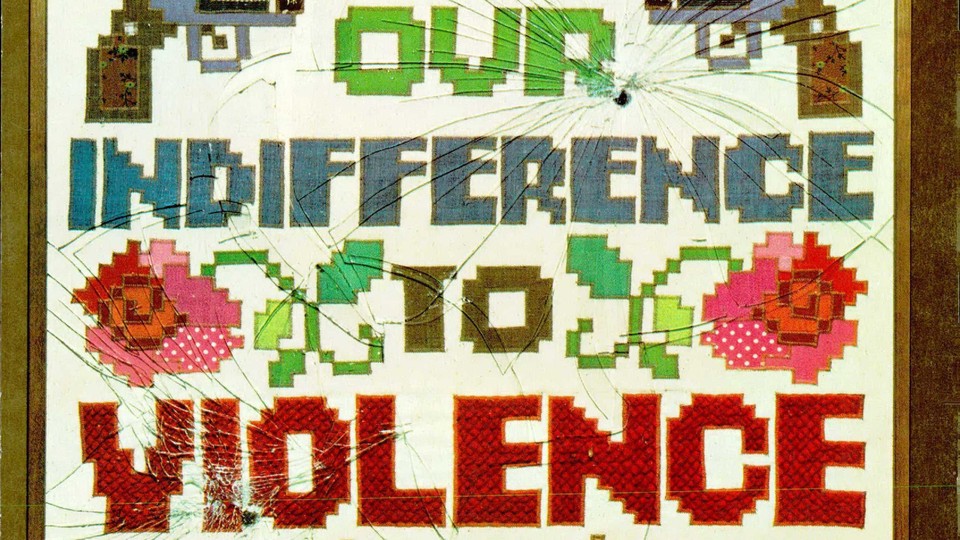 The Atlantic's December 1974 cover: A needlepoint illustration topped with two pistols over the colorful text, 'OUR INDIFFERENCE TO VIOLENCE