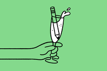 An illustration of a champagne glass with a pencil inside