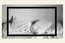 An image of rumpled white pillows on top of a bed