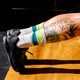 a photo of the tattooed calves of a person in plank position