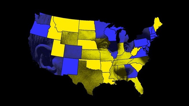 Blue and yellow map of the United States imposed over a faint outline of Putin, all on a black background