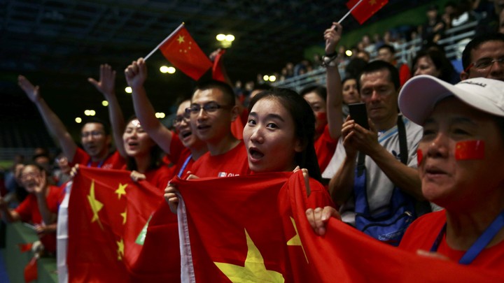 Fans cheer on Chinese athletes at the 2016 Olympics.