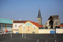 A playground is in the foreground. A church steeple is behind it.