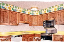 An illustration of a bright kitchen with floral border and wooden cabinets