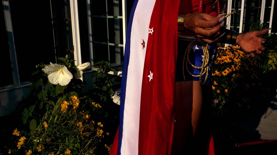 A waist-down view of a reveler wearing a red, white, and blue flag