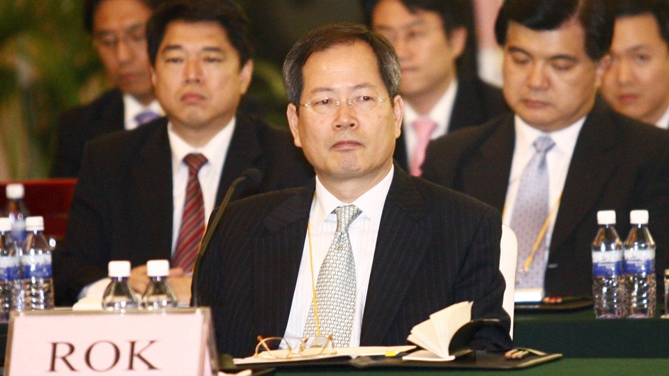 Chun Yung Woo sitting at a lectern