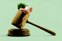 A gavel rests on a gavel block; the gavel’s mallet is a paper grocery bag full to the brim.