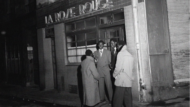 Paris, France: Four Black men stand outside La Rose Rouge, December 4, 1948.