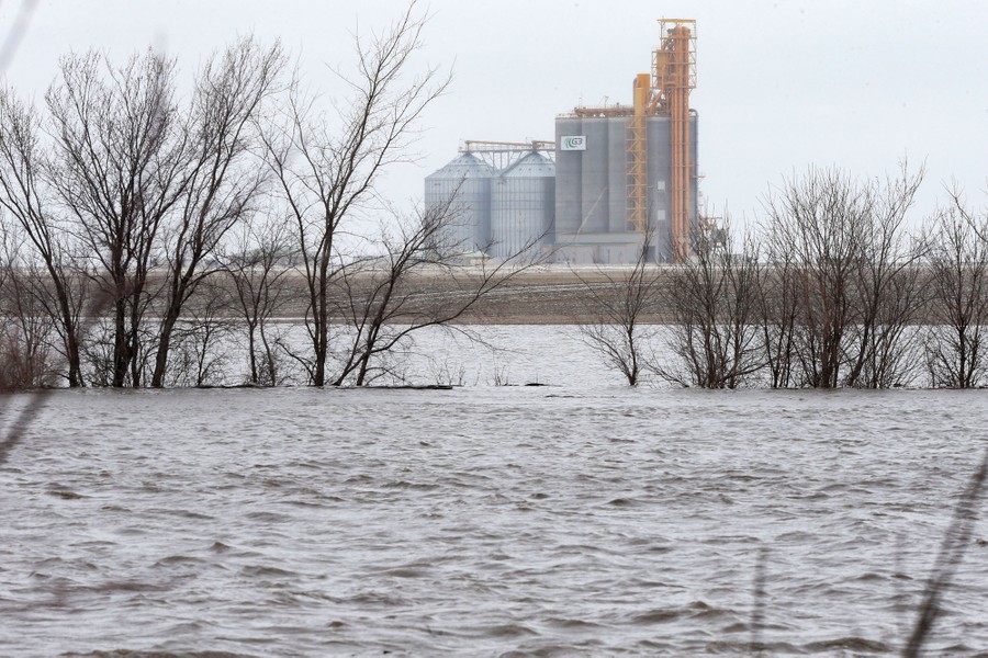 Grain elevators in the distance, beyond a broad flooded area