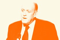 Francis Davis in a suit speaking into a microphone