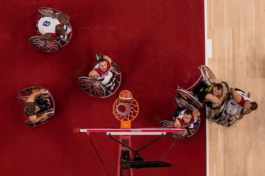 A view from above of wheelchair-basketball players beneath the net.