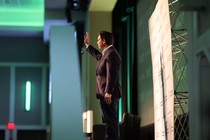 Ron DeSantis waving on stage at the 2024 Iowa Renewable Fuels Association Summit