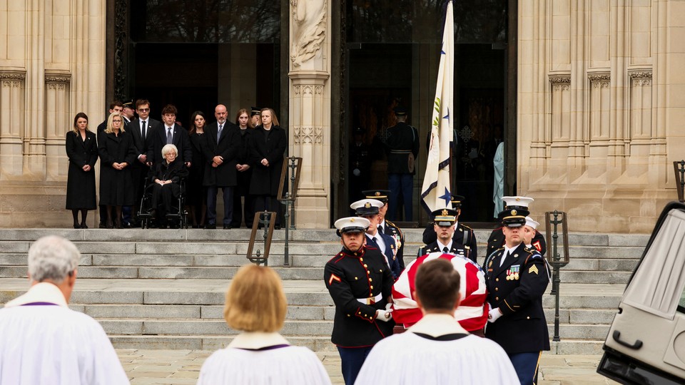 Photo of the Cheney family outside the National Cathedral watching as men in uniform carry Dick Cheney's casket.