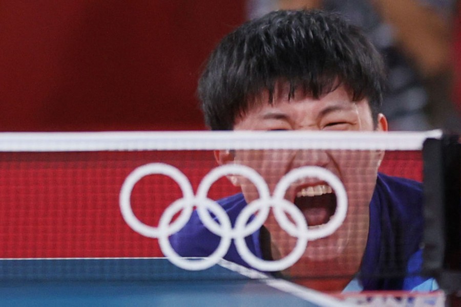 A table tennis player shots during a match.