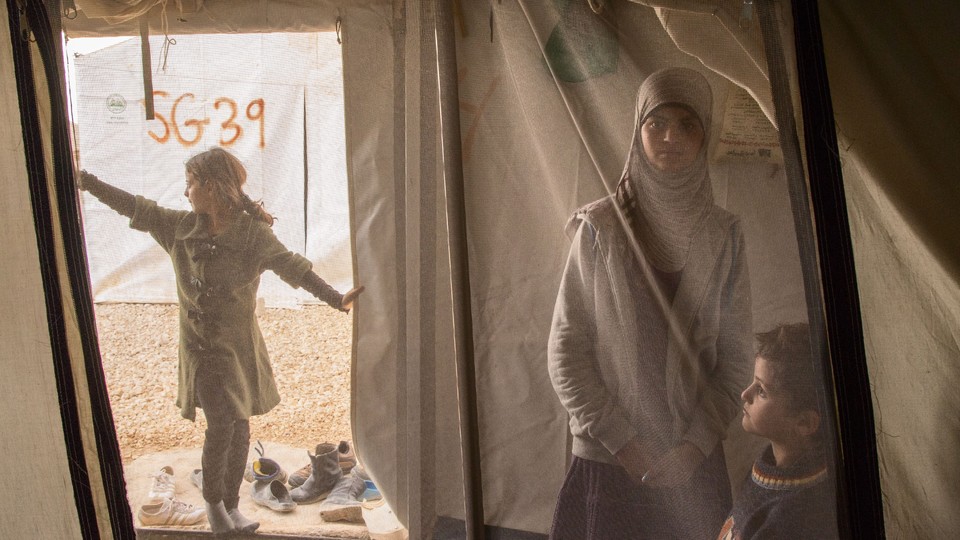 Syrian children inside a camp tent