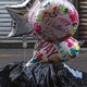 Balloons with the words Happy Mother's Day are on the ground stuff in a trash bag