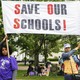 Students of the East Ramapo School District hold a sign that reads "Save our schools!" 