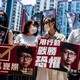 Prodemocracy activists hold signs in Hong Kong.