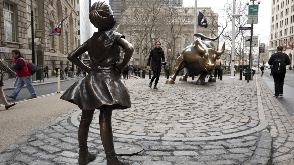 The "Fearless Girl" statue faces down Wall Street's famous Charging Bull.