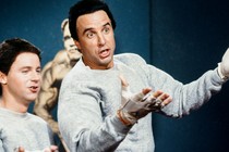 Two men in gray sweatsuits gesticulate while talking in a "Hans and Franz" sketch from SNL.