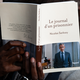 Photograph of someone reading a paperback French edition of Sarkozy's book "Diary of a Prisoner"