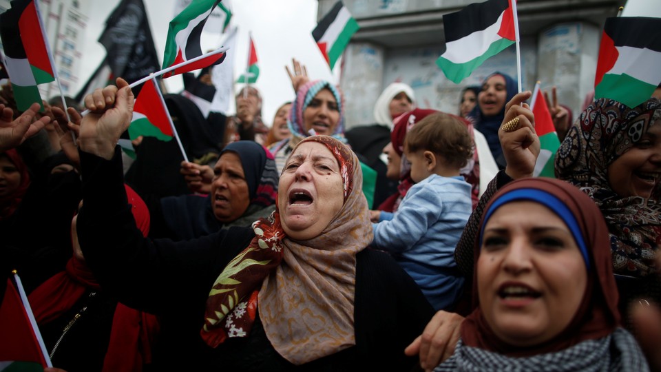 Palestinian women shout slogans during a protest in Gaza City. 