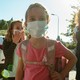 Photo of several children and a few adults wearing face masks