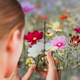 A book with pages full of flowers that merge with the flowers in the background