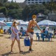Tourists wearing face masks on a beach in Mexico