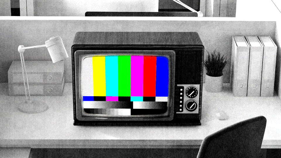 An old-school TV sitting on an office desk displays a shifting TV test card on its screen.