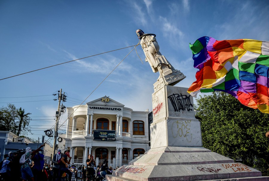 Demonstrators tear down a statue of Christopher Columbus in Colombia.