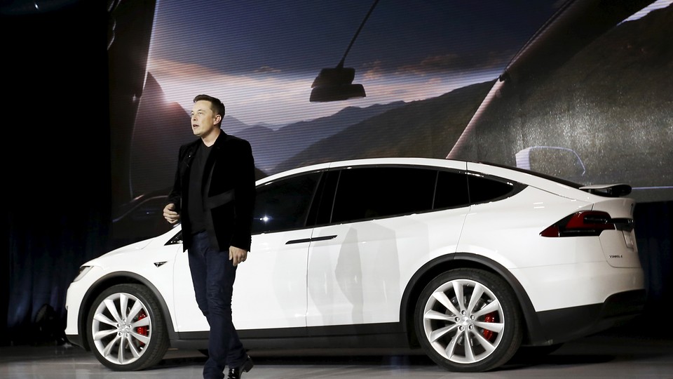 Elon Musk, the founder of Tesla, presents one of his company's cars in 2015.