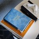 A book titled "Living Sober," spiral notebooks, and a tissue box on a table