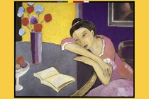 Painting of woman with her head resting on her forearms, looking at a book open on the table