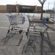 Two shopping carts in a Walmart parking lot 