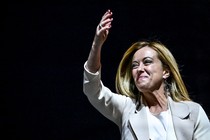Italian politician Giorgia Meloni smiling and waving